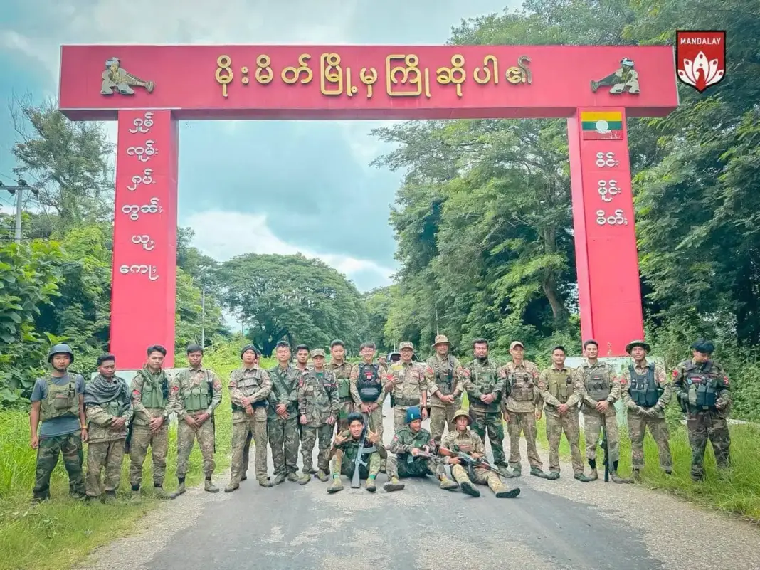 MDY-PDF In Front of Mong Mit Signboard MDY-PDF In Front of Mong Mit Signboard
